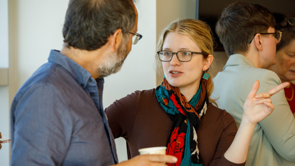 Alyssa Bilinski chats with a colleague